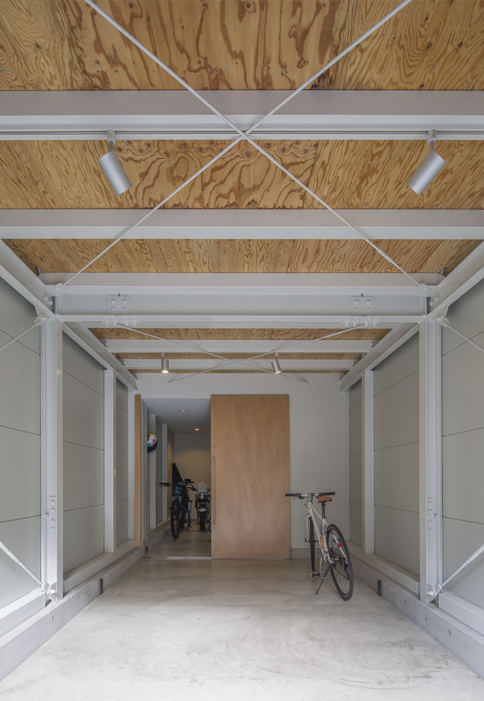 Esempio di un piccolo garage per un'auto connesso moderno con ufficio, studio o laboratorio