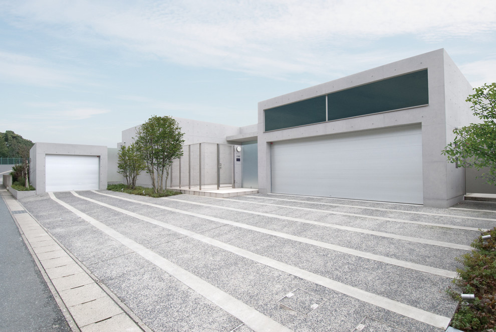 This is an example of a modern carport in Tokyo with three or more cars.