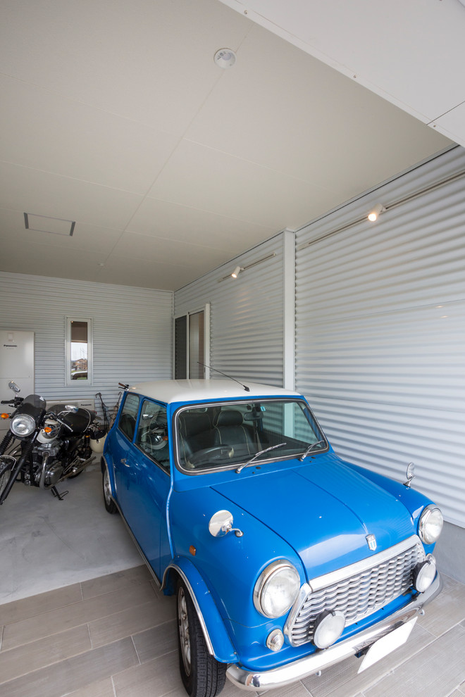 Inspiration for a tropical one-car garage remodel in Nagoya