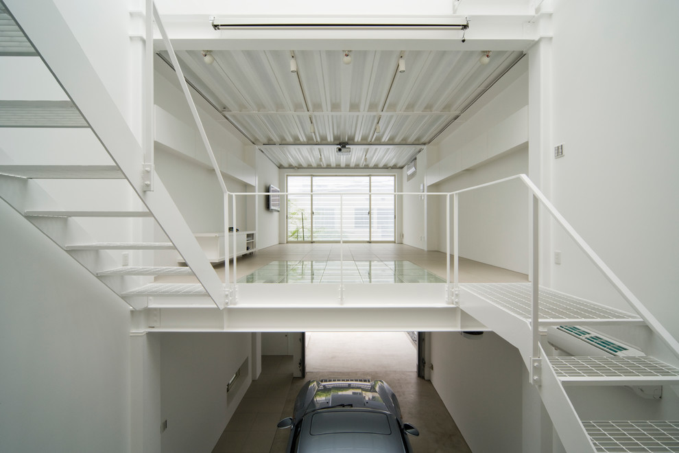 На фото: пристроенный гараж в стиле модернизм для одной машины с