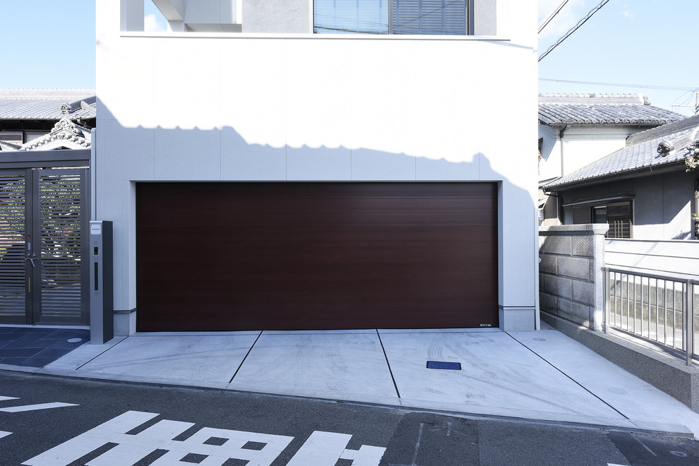 This is an example of a modern attached double garage in Other.