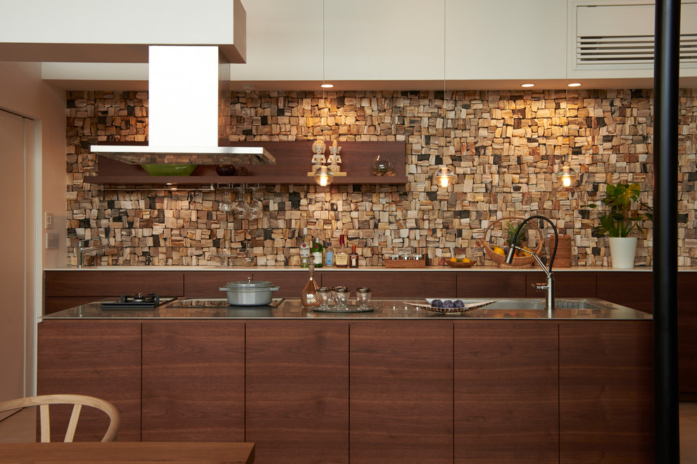 Idéer för orientaliska linjära brunt kök, med en integrerad diskho, släta luckor, skåp i mörkt trä, bänkskiva i rostfritt stål, en köksö och brunt golv
