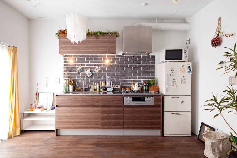 Inspiration for a small modern single-wall open plan kitchen in Tokyo with an integrated sink, flat-panel cabinets, medium wood cabinets, stainless steel worktops, brown splashback, ceramic splashback, white appliances, medium hardwood flooring and no island.