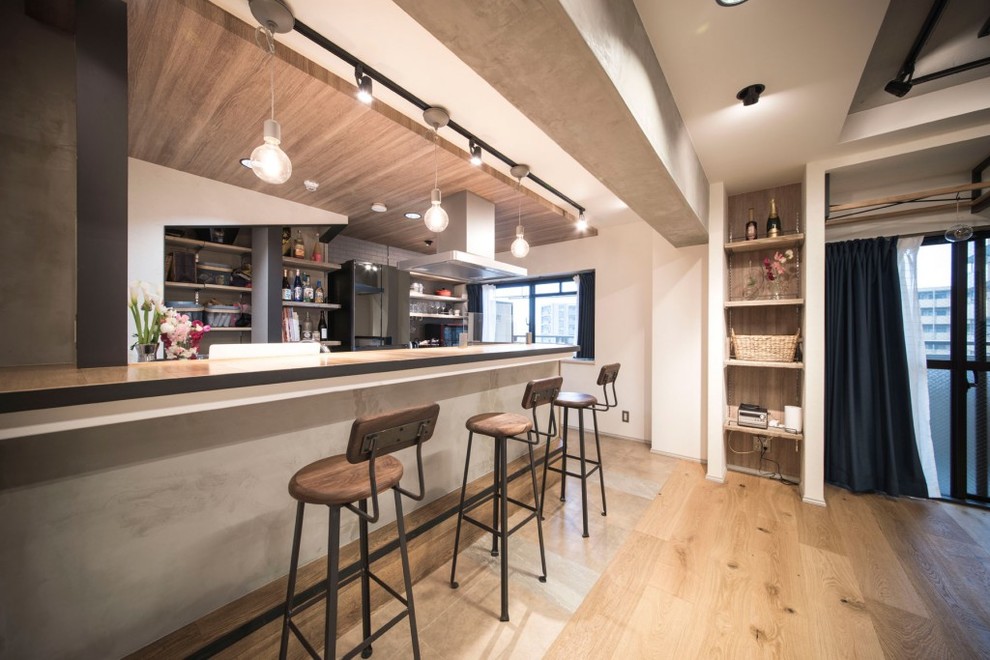 Design ideas for an industrial open plan kitchen in Tokyo with light hardwood flooring and beige floors.