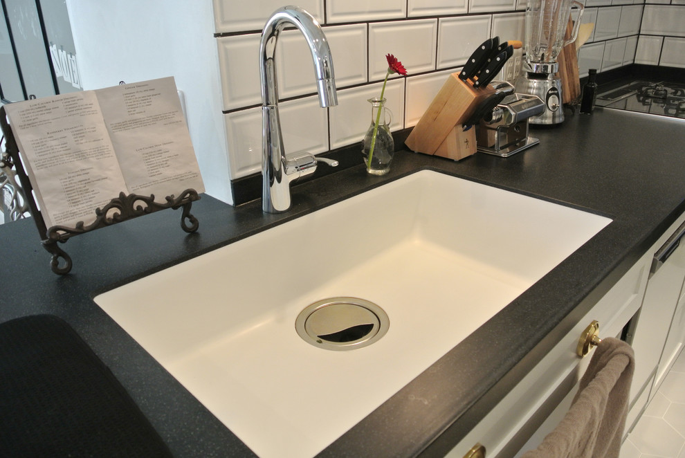 This is an example of a medium sized contemporary galley kitchen/diner in Nagoya with a submerged sink, recessed-panel cabinets, white cabinets, white splashback, metro tiled splashback, stainless steel appliances, ceramic flooring and a breakfast bar.