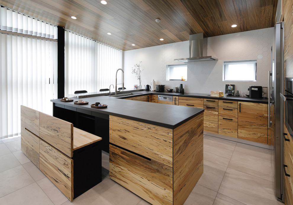 Design ideas for an expansive modern u-shaped open plan kitchen in Tokyo with a submerged sink, flat-panel cabinets, medium wood cabinets, engineered stone countertops, beige splashback, wood splashback, stainless steel appliances, porcelain flooring, no island, grey floors and black worktops.
