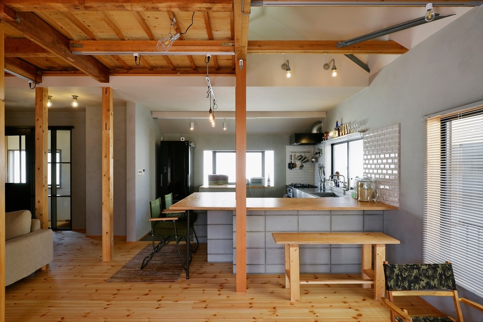 中くらいなインダストリアルスタイルのおしゃれなキッチン (一体型シンク、無垢フローリング、茶色い床、茶色いキッチンカウンター) の写真