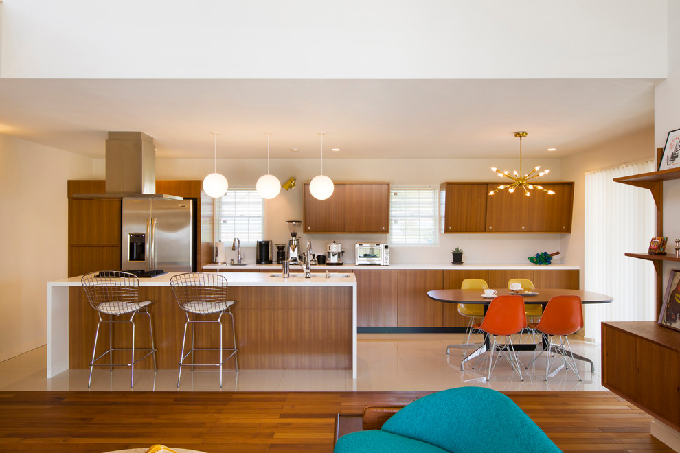 Esempio di una cucina moderna con lavello sottopiano, ante lisce, ante in legno scuro, elettrodomestici in acciaio inossidabile, pavimento beige e top bianco