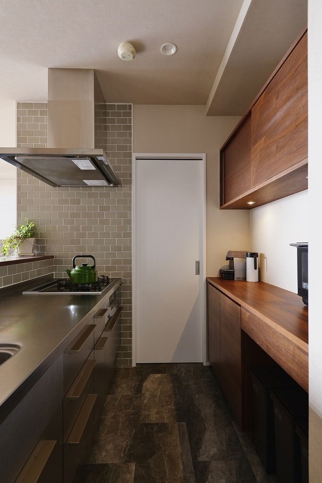 На фото: прямая кухня-гостиная в восточном стиле с одинарной мойкой, плоскими фасадами, полуостровом и коричневым полом с