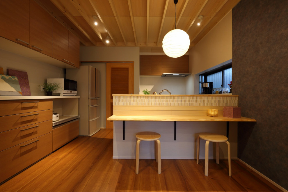 Arts and crafts galley plywood floor, brown floor and wood ceiling eat-in kitchen photo in Other with an undermount sink, flat-panel cabinets, brown cabinets, solid surface countertops and white countertops