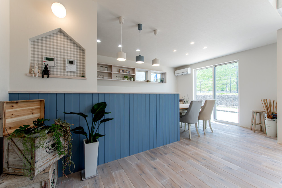 Источник вдохновения для домашнего уюта: прямая кухня с обеденным столом, синими фасадами и потолком с обоями
