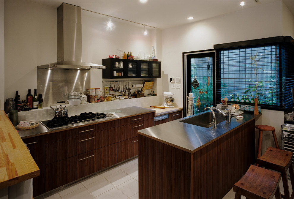大阪にある北欧スタイルのおしゃれなII型キッチン (シングルシンク、フラットパネル扉のキャビネット、濃色木目調キャビネット、ステンレスカウンター、白いキッチンパネル、セラミックタイルのキッチンパネル、アイランドなし、白い床) の写真