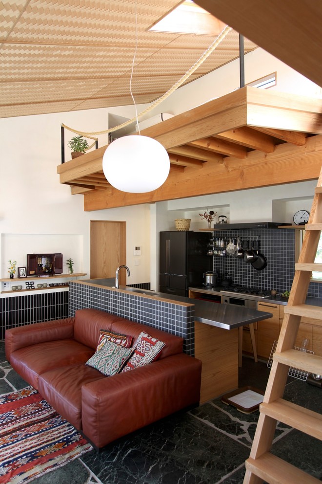 Contemporary galley open plan kitchen in Tokyo Suburbs with flat-panel cabinets, medium wood cabinets, stainless steel worktops, black splashback, mosaic tiled splashback, stainless steel appliances, an island and grey floors.