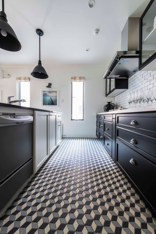 Example of a transitional single-wall ceramic tile kitchen design in Other with black cabinets, solid surface countertops, white backsplash, porcelain backsplash and an island
