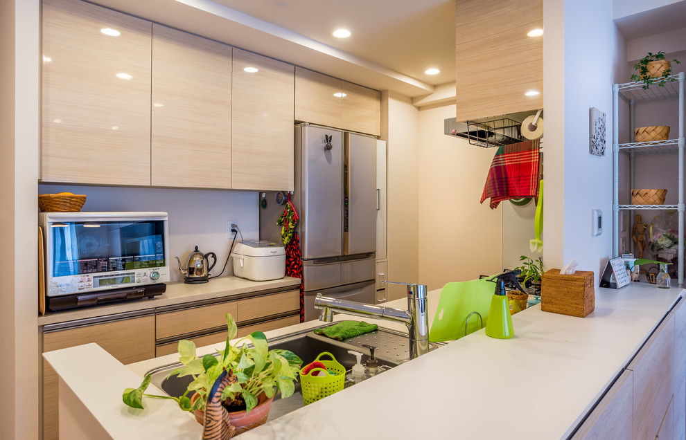 Medium sized world-inspired galley open plan kitchen in Other with a submerged sink, beaded cabinets, beige cabinets, composite countertops, white splashback, white appliances, plywood flooring and brown floors.