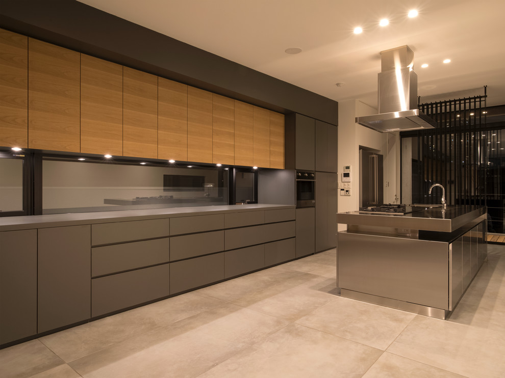 Contemporary single-wall kitchen in Tokyo with flat-panel cabinets, grey cabinets, stainless steel worktops, grey splashback, an island and beige floors.