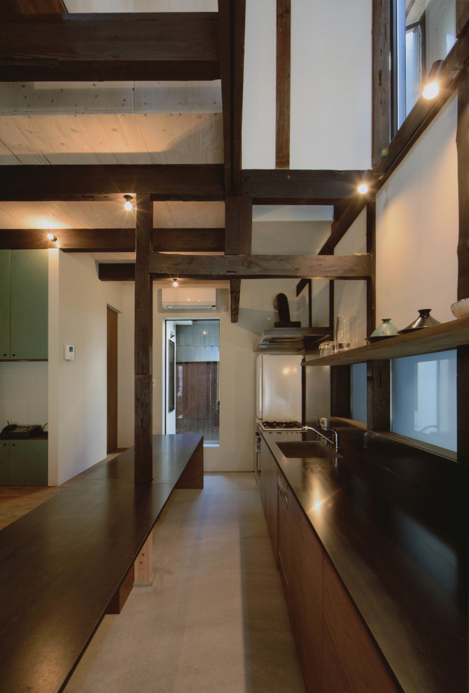 京都にあるアジアンスタイルのおしゃれなII型キッチン (一体型シンク、フラットパネル扉のキャビネット、茶色いキャビネット、木材カウンター、無垢フローリング) の写真