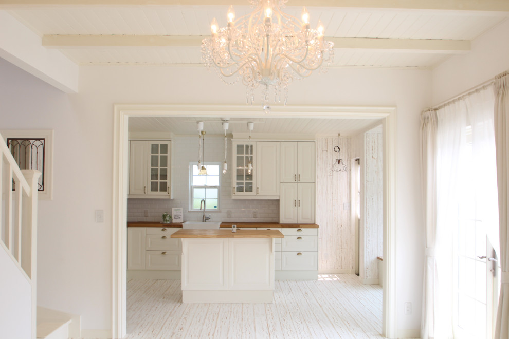 Idee per una grande cucina stile shabby con ante bianche, top in legno, paraspruzzi bianco, parquet chiaro, pavimento bianco e soffitto in legno