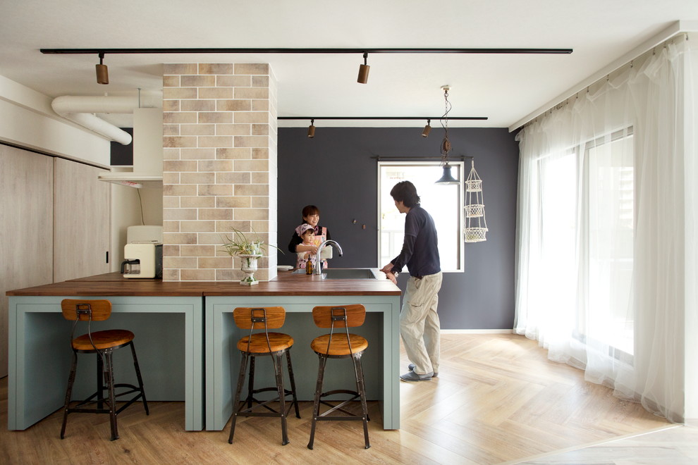 Diseño de cocina contemporánea con fregadero bajoencimera, suelo de madera clara, una isla y encimera de madera