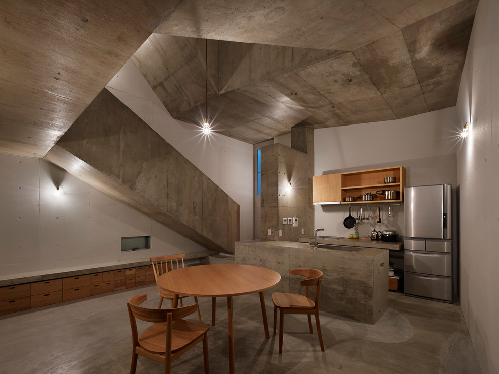 Foto de cocina minimalista con salpicadero blanco y suelo de cemento