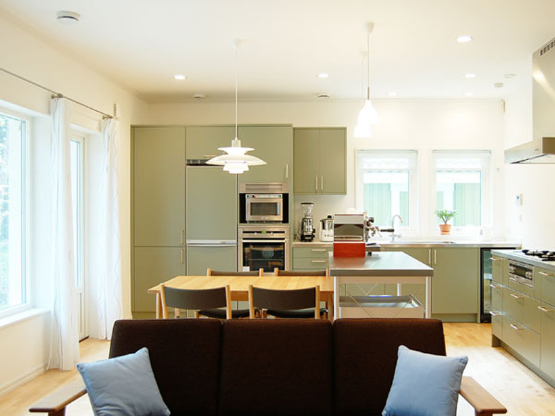 Example of a mid-sized danish l-shaped open concept kitchen design in Kobe with beaded inset cabinets, green cabinets, stainless steel countertops and an island