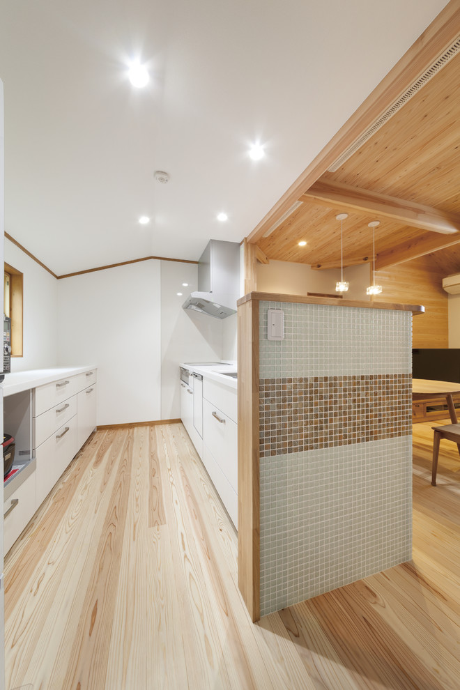 Photo of a world-inspired kitchen in Tokyo Suburbs with light hardwood flooring.