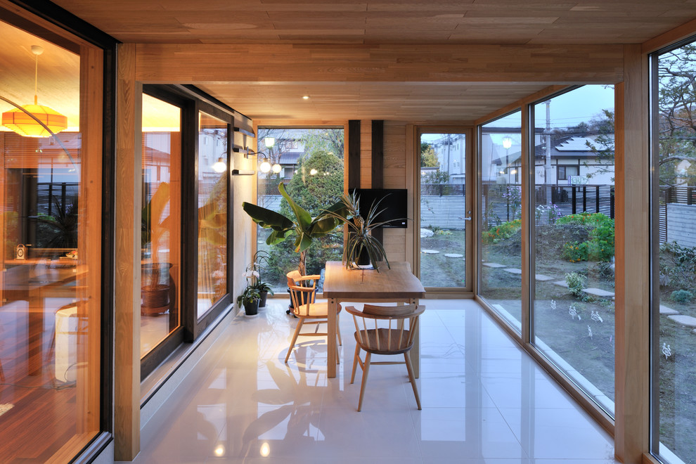 This is an example of a world-inspired conservatory in Sapporo with a standard ceiling and white floors.