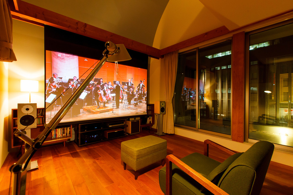 Example of a minimalist home theater design in Other with a projector screen