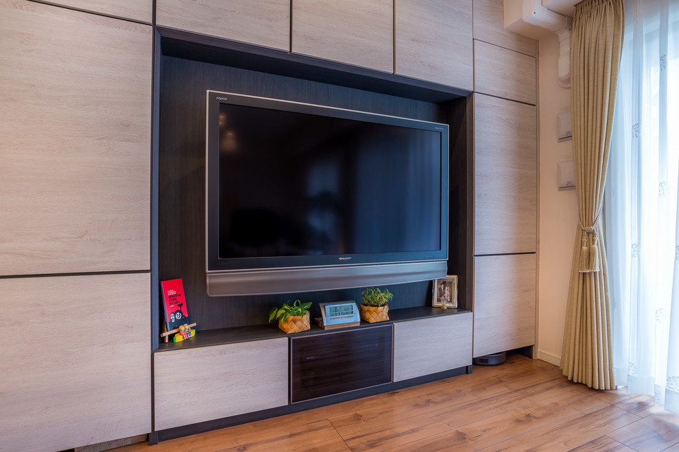 Foto på ett stort nordiskt öppen hemmabio, med vita väggar, plywoodgolv, en väggmonterad TV och brunt golv