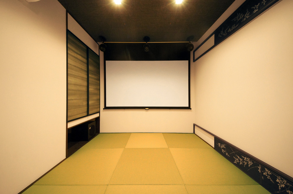 Foto di un piccolo home theatre design chiuso con pareti beige e schermo di proiezione
