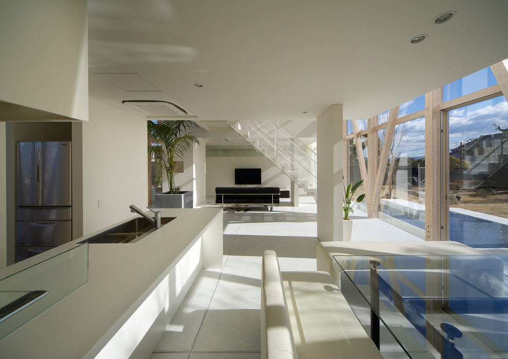 На фото: столовая в стиле модернизм с белыми стенами и полом из керамической плитки без камина с