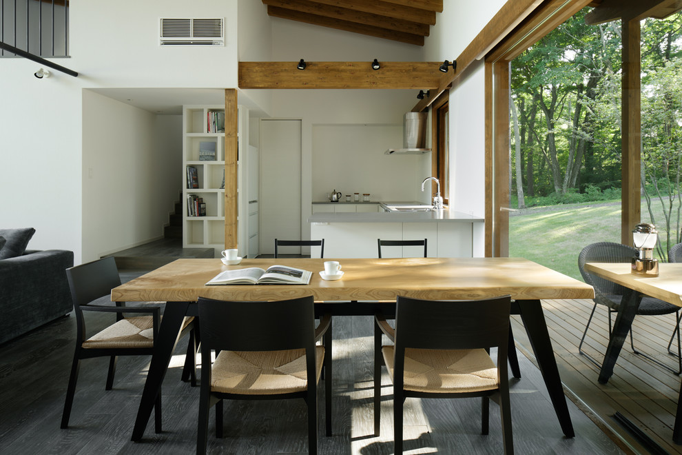Foto di una sala da pranzo aperta verso il soggiorno design con pareti bianche e pavimento in legno massello medio