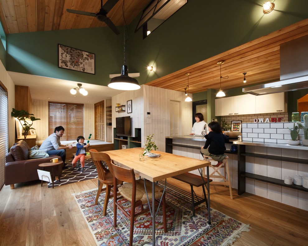 Idee per una sala da pranzo scandinava con pavimento in legno massello medio, pavimento marrone e pareti verdi
