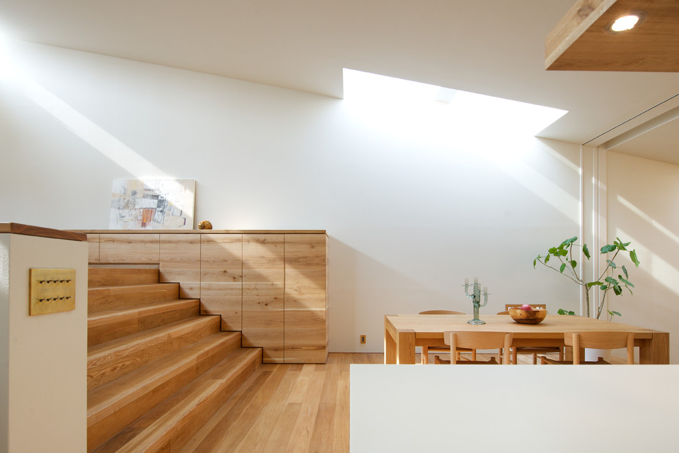 Great room - scandinavian medium tone wood floor great room idea in Osaka with white walls and no fireplace