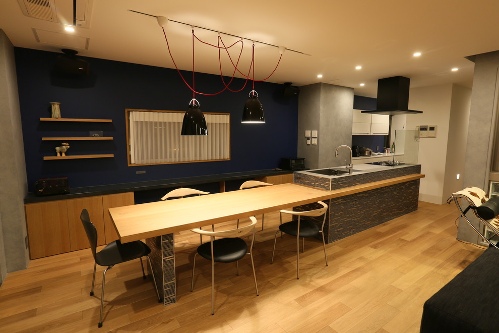 This is an example of a contemporary open plan dining room in Other with grey walls and light hardwood flooring.