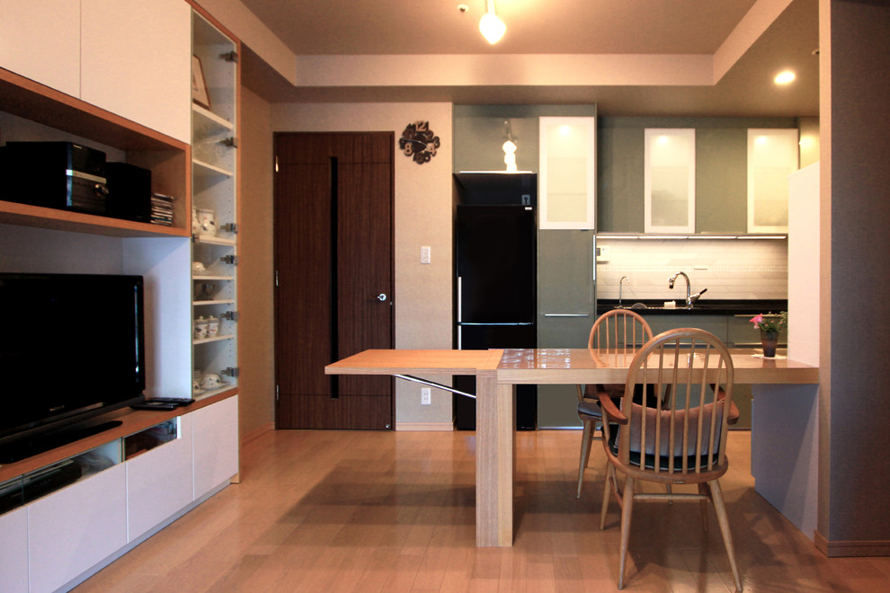 Idee per una sala da pranzo aperta verso il soggiorno minimalista di medie dimensioni con pareti beige e pavimento in compensato