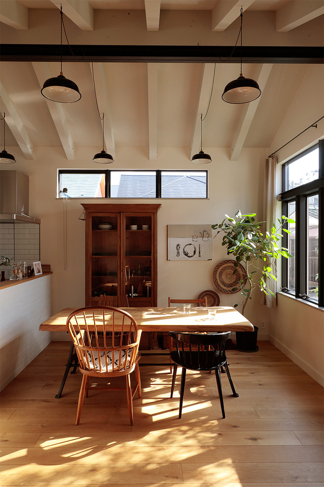 Design ideas for a scandi dining room in Tokyo Suburbs with white walls, medium hardwood flooring and brown floors.