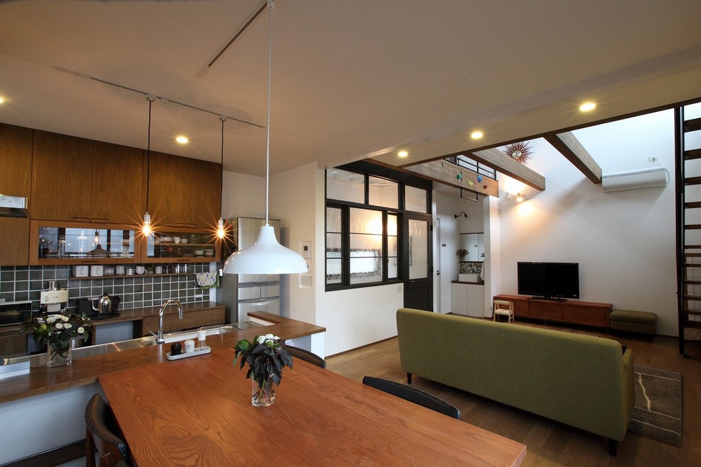 Dining room - contemporary medium tone wood floor and brown floor dining room idea in Osaka with white walls