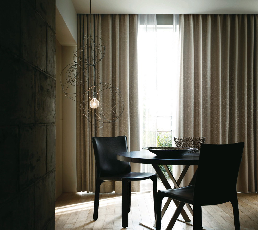 Photo of a contemporary dining room in Osaka with beige walls, light hardwood flooring and no fireplace.
