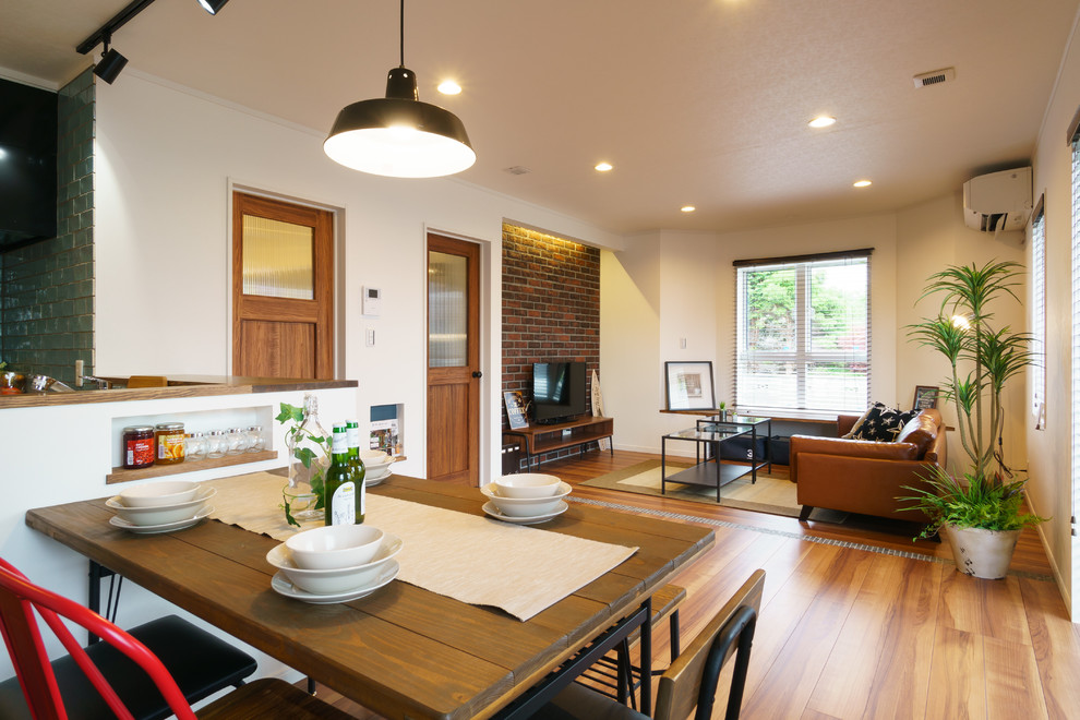 This is an example of a beach style open plan dining room in Other with white walls, medium hardwood flooring and brown floors.