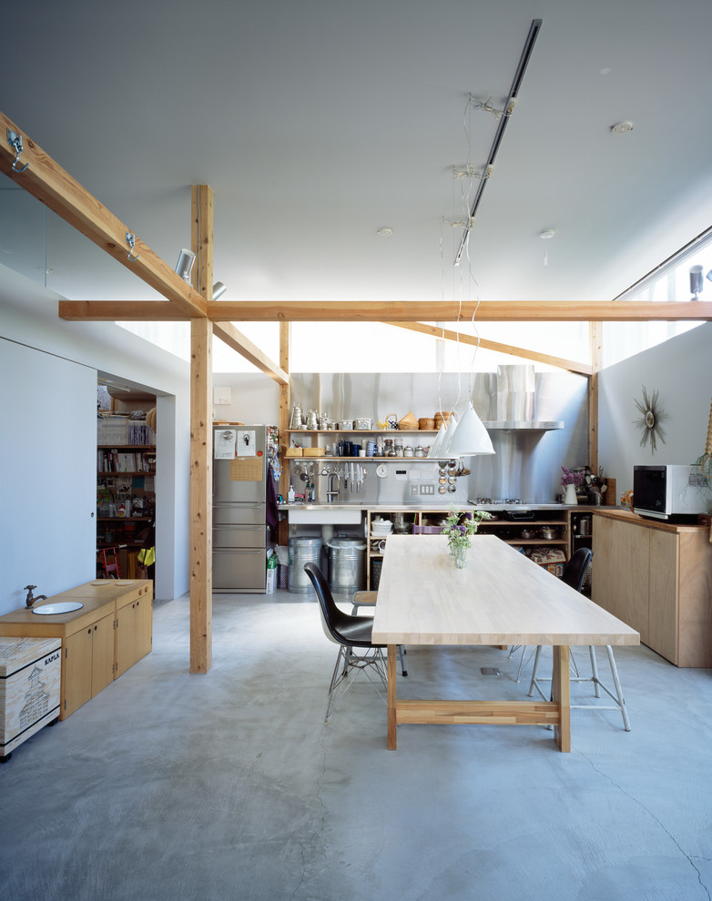 Photo of an industrial kitchen/dining room in Tokyo with white walls, concrete flooring and no fireplace.