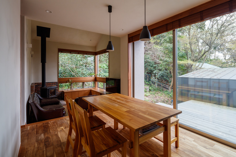 Asian medium tone wood floor and brown floor great room photo in Other with white walls