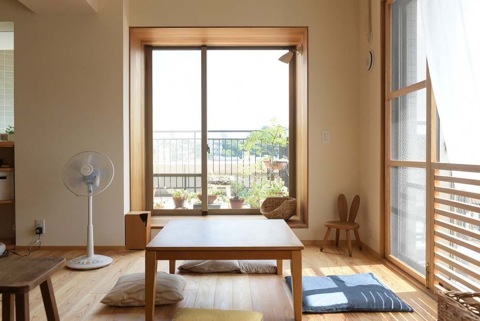 Medium tone wood floor and brown floor dining room photo in Tokyo with white walls