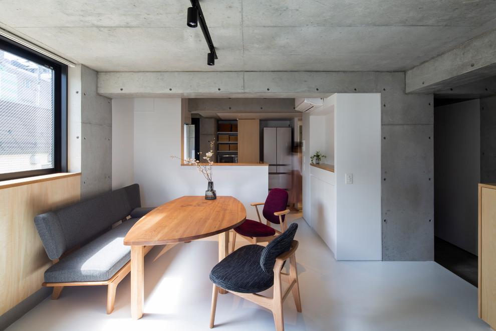 Photo of a world-inspired dining room in Tokyo with grey walls and white floors.