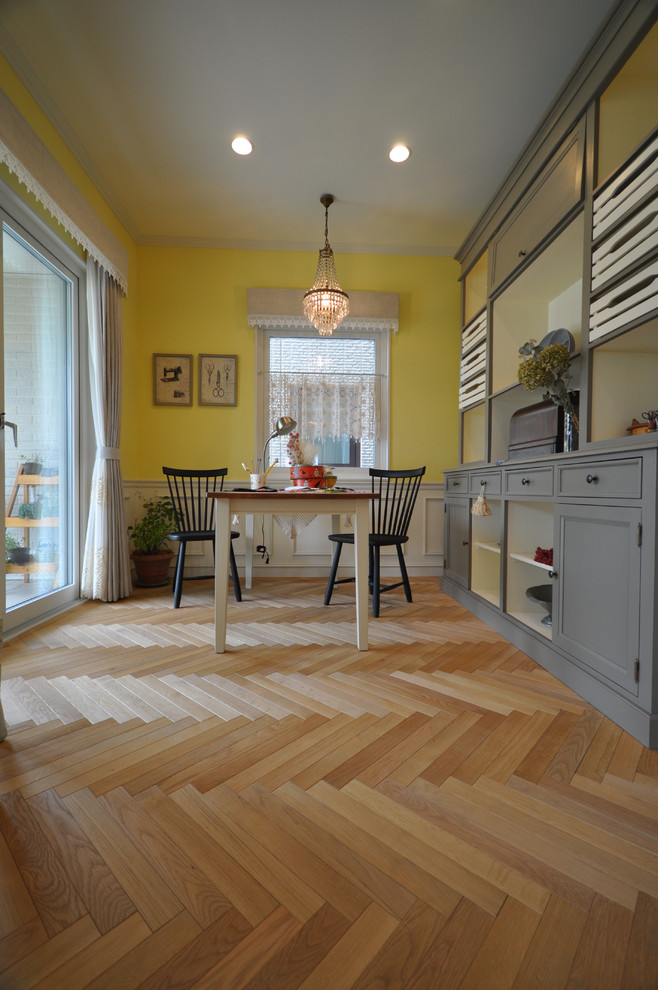 Idéer för att renovera en minimalistisk matplats, med gula väggar, mellanmörkt trägolv och beiget golv