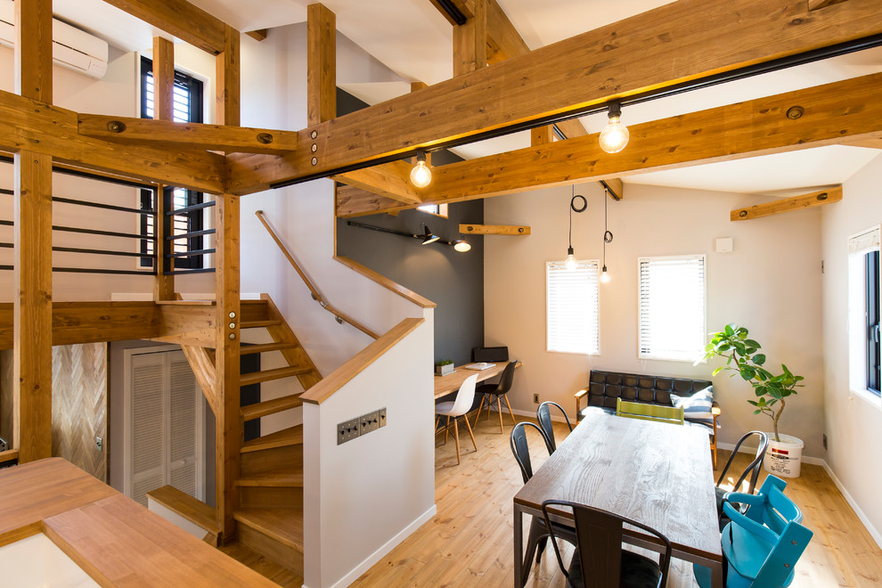 This is an example of an industrial kitchen/dining room in Other with grey walls, medium hardwood flooring and white floors.