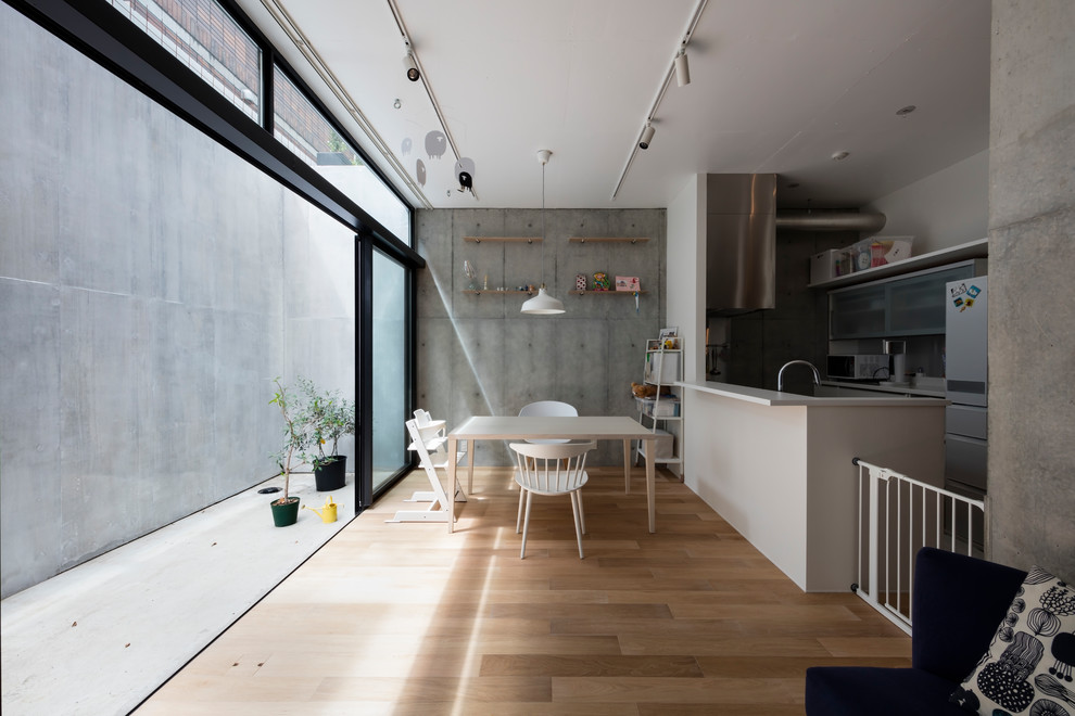 Diseño de comedor industrial con paredes grises, suelo de madera clara y suelo beige