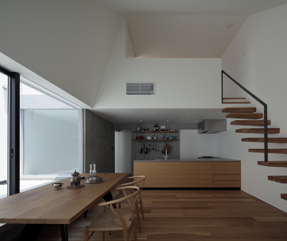 Inspiration for a modern open plan dining room in Tokyo with white walls, medium hardwood flooring and brown floors.
