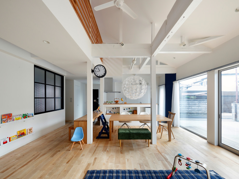 Inspiration for a scandinavian light wood floor and brown floor dining room remodel in Osaka with white walls