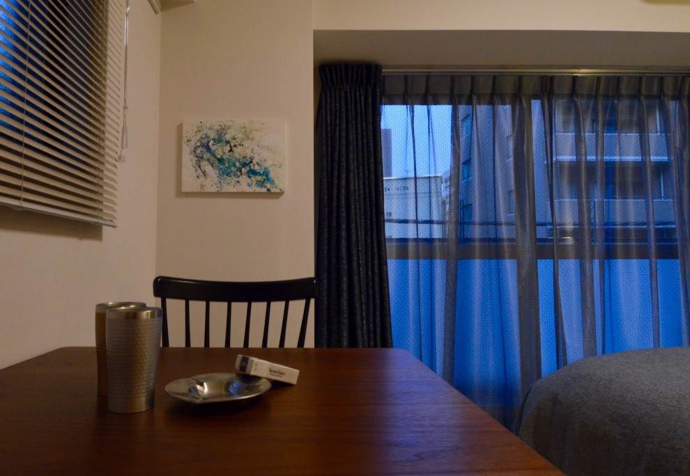 Immagine di una piccola sala da pranzo aperta verso il soggiorno industriale con pareti bianche e parquet chiaro